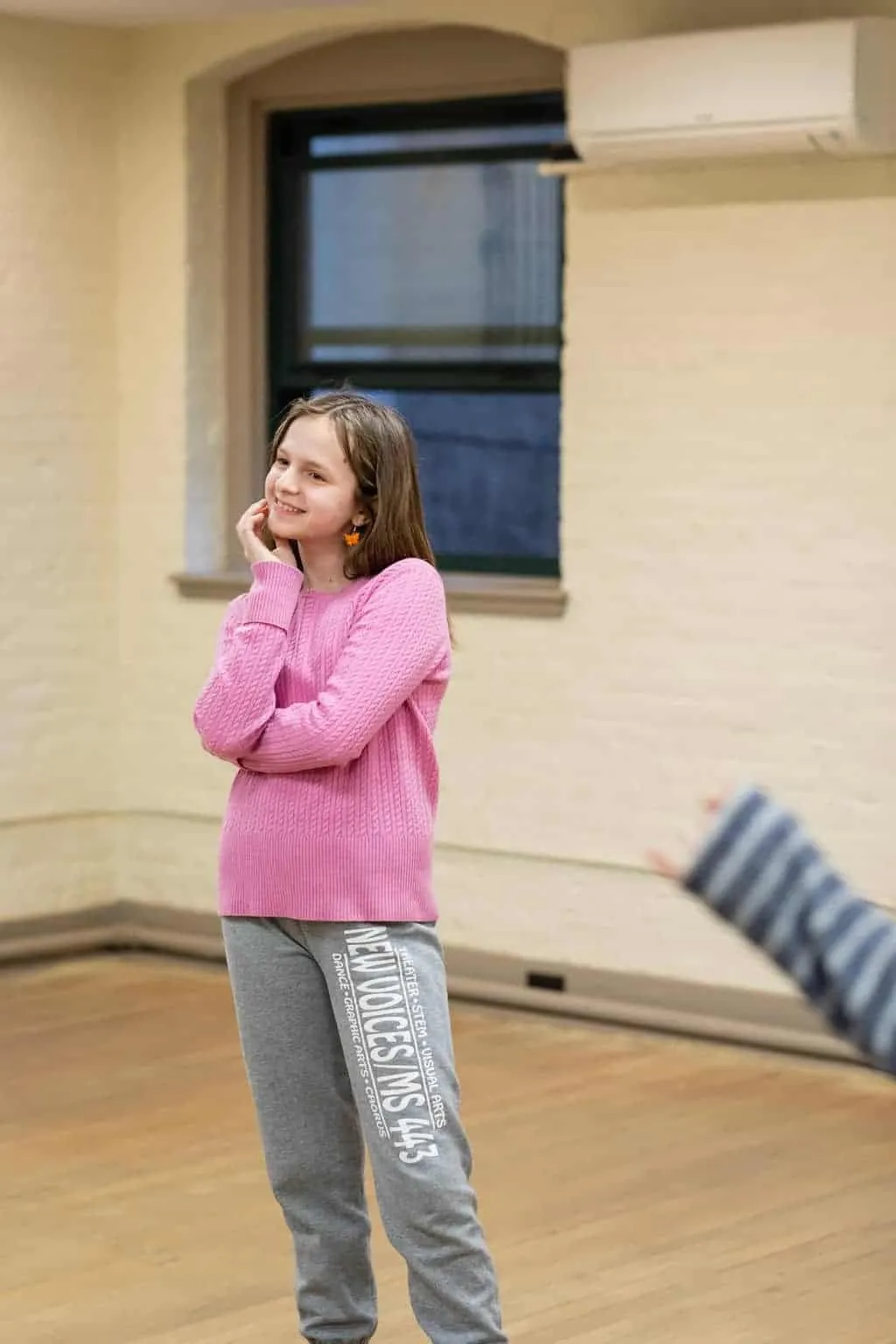 Young student smiling, representing the joy of performing arts